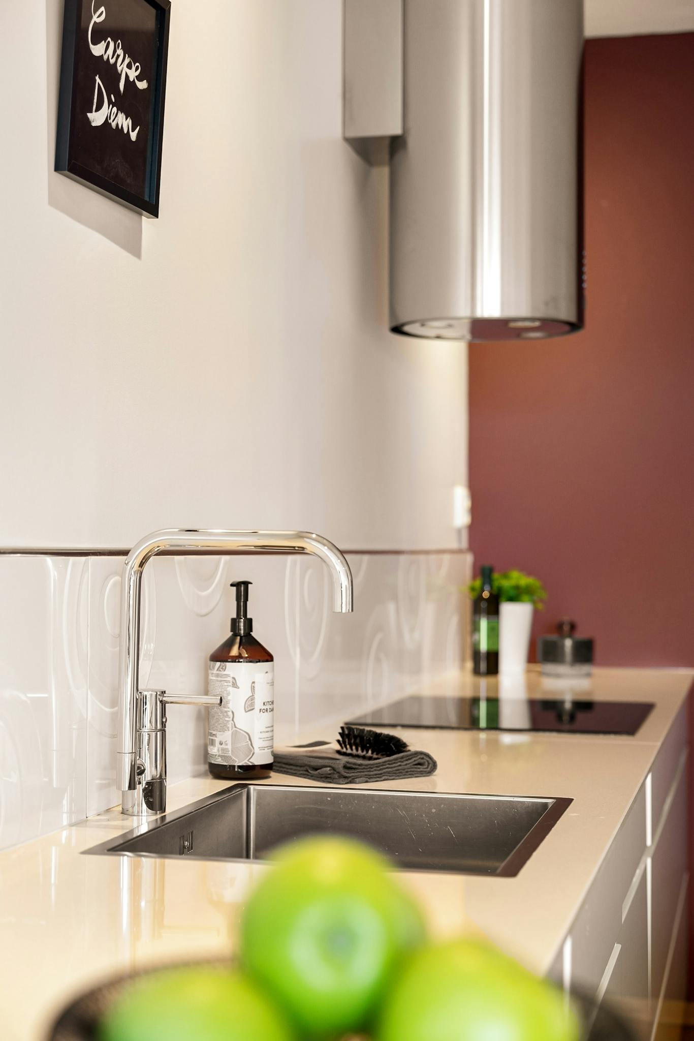 A sleek kitchen interior featuring a modern sink and minimalist design elements for a stylish living space.